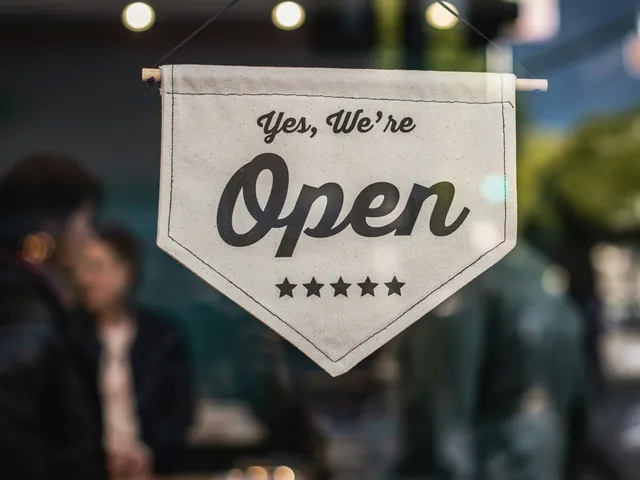 A “Yes, we're open” sign hanging in a window
