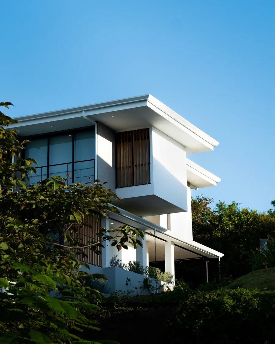 A modern white house against a blue sky