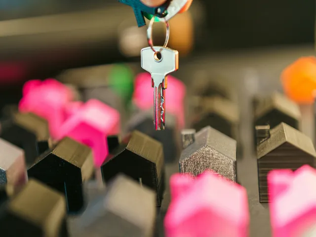 House keys hanging over rows of model houses